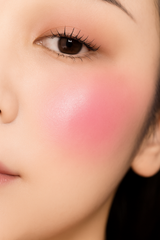 Close-up of a person's face with pink blush on cheeks